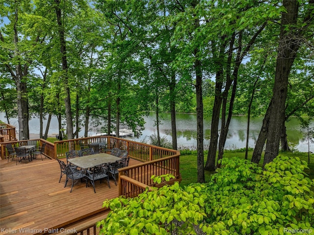 3120 Pond Rd, Leonard, MI 48367 - wooden deck with outdoor dining area and a water view