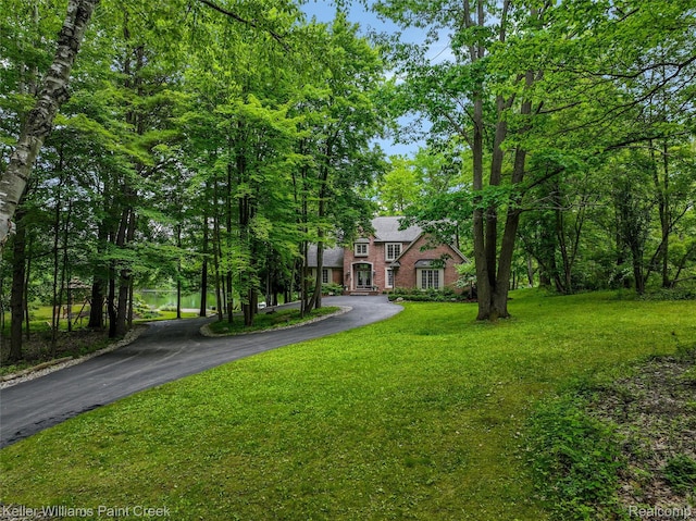 3120 Pond Rd, Leonard, MI 48367 - view of front of home with asphalt driveway and a front yard