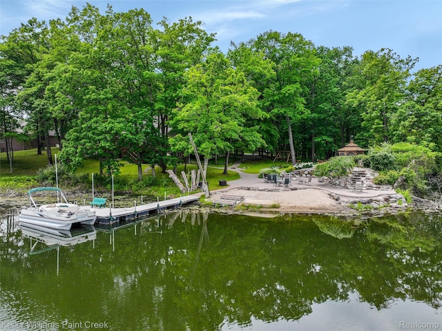 3120 Pond Rd, Leonard, MI 48367 - dock featuring view of wooded area