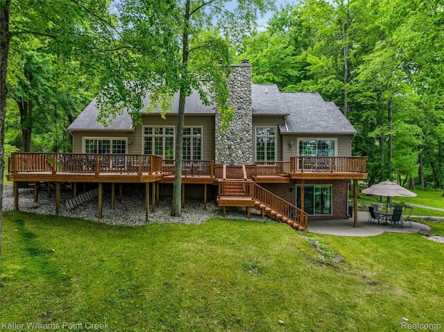 3120 Pond Rd, Leonard, MI 48367 - back of property featuring a patio area, a wooden deck, a chimney, a lawn, and stairs