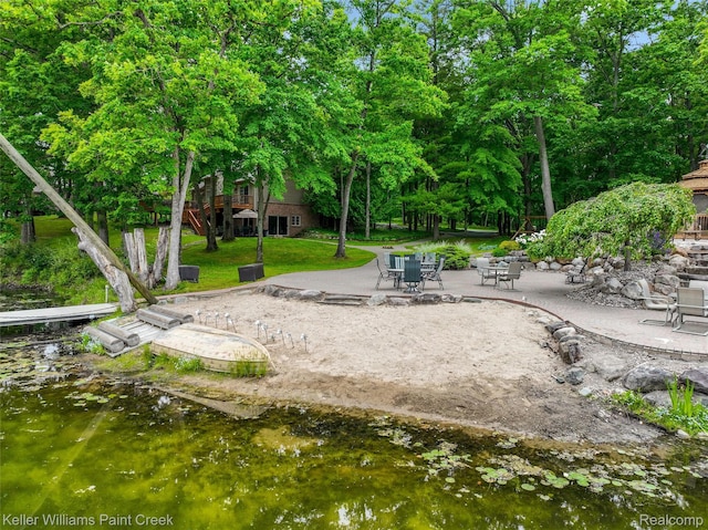 3120 Pond Rd, Leonard, MI 48367 - view of grassy yard with a patio, view of scattered trees, and stairway