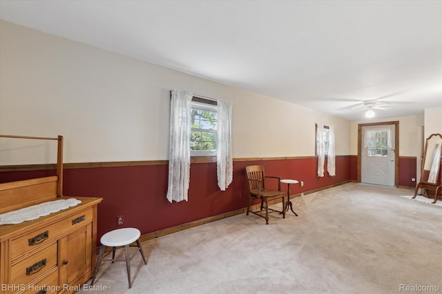 301 N Church St, Byron, MI 48418 - sitting room featuring a ceiling fan, light colored carpet, and a wainscoted wall
