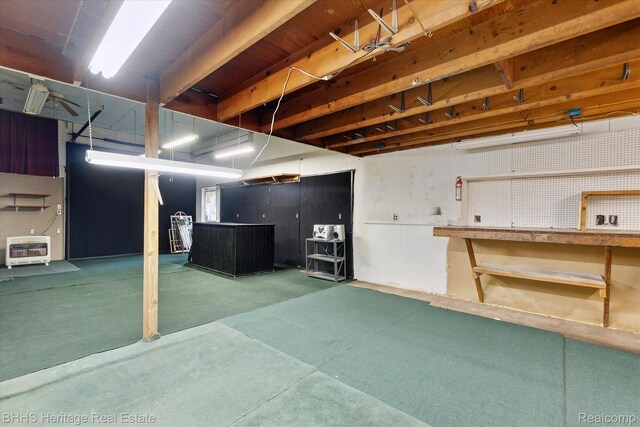 301 N Church St, Byron, MI 48418 - basement featuring a workshop area, heating unit, carpet flooring, and a bar