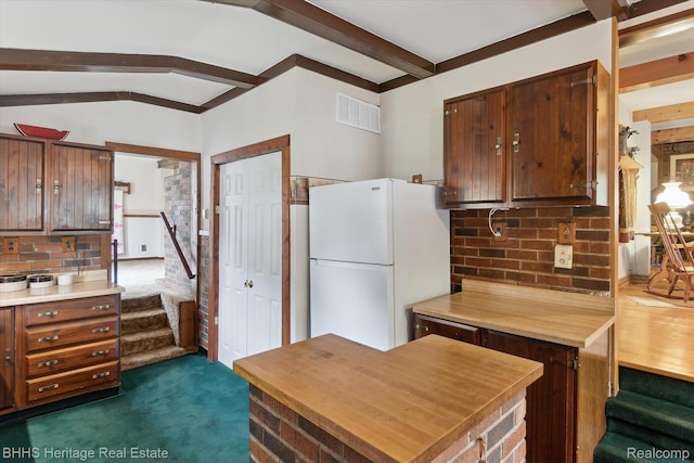 301 N Church St, Byron, MI 48418 - kitchen with freestanding refrigerator, tasteful backsplash, and dark colored carpet