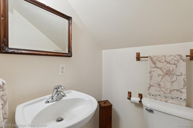 301 N Church St, Byron, MI 48418 - half bath with a sink, toilet, and lofted ceiling