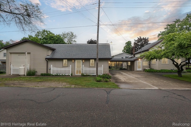 301 N Church St, Byron, MI 48418 - view of front facade featuring roof with shingles, driveway, and a fenced front yard
