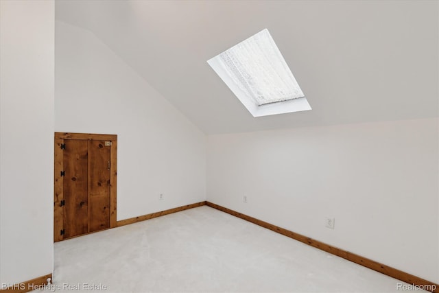 301 N Church St, Byron, MI 48418 - additional living space with a skylight, vaulted ceiling, light carpet, and baseboards