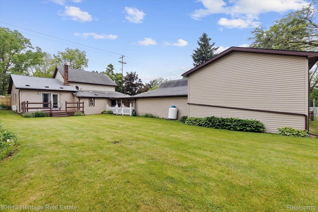 301 N Church St, Byron, MI 48418 - view of grassy yard with a wooden deck
