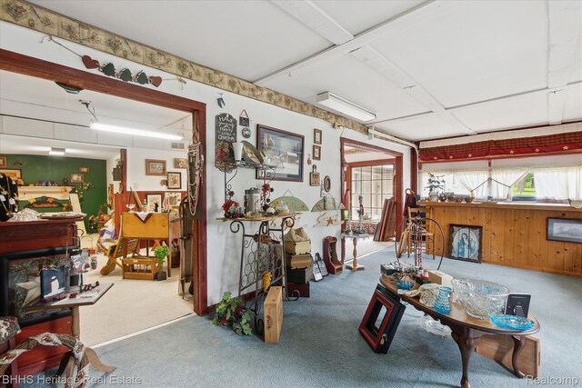 301 N Church St, Byron, MI 48418 - living room featuring carpet and wooden walls