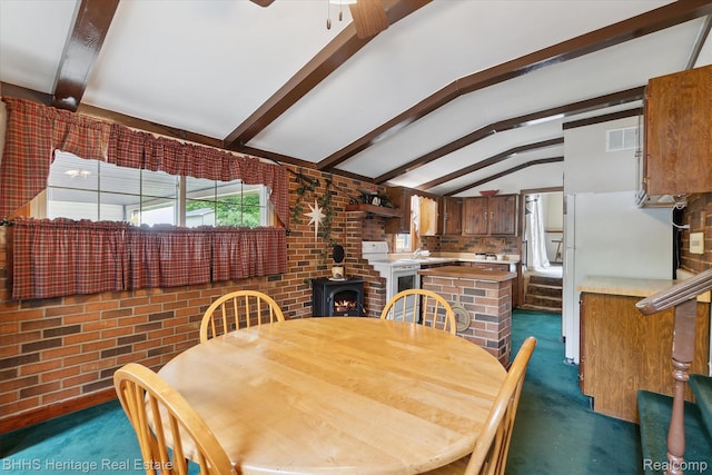 301 N Church St, Byron, MI 48418 - dining room featuring dark carpet, a ceiling fan, and brick wall