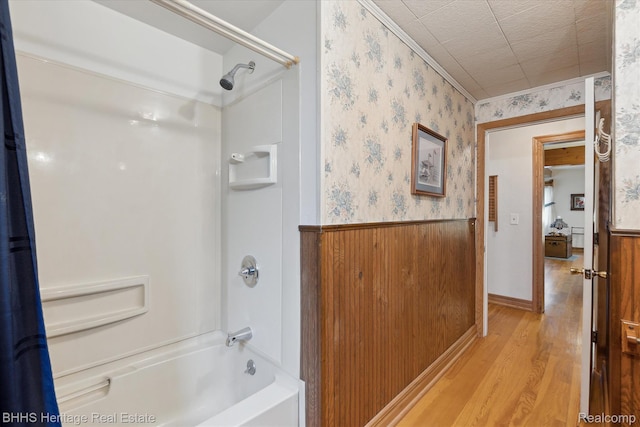 301 N Church St, Byron, MI 48418 - bathroom featuring wainscoting, shower / bath combination, wood finished floors, and wallpapered walls