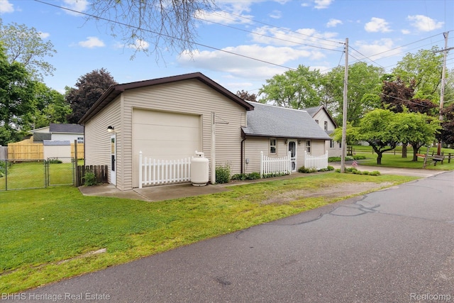 301 N Church St, Byron, MI 48418 - view of property exterior with a gate, a detached garage, and roof with shingles