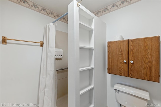 301 N Church St, Byron, MI 48418 - bathroom featuring toilet, built in features, and curtained shower
