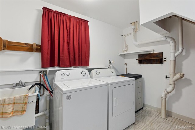 301 N Church St, Byron, MI 48418 - washroom with separate washer and dryer and baseboards