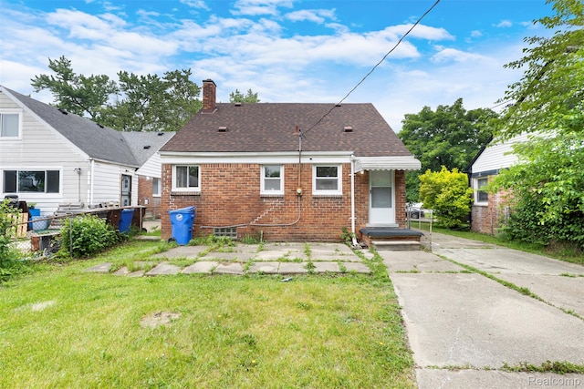 1621 Fairbairn St, Dearborn, MI 48141 - back of property with a chimney, brick siding, a yard, driveway, and a shingled roof