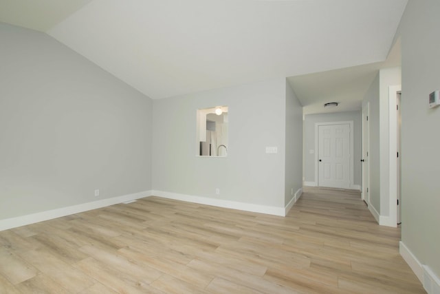 81 Skyline Cir NW, Grand Rapids, MI 49504 - empty room with light wood-style floors, baseboards, and lofted ceiling