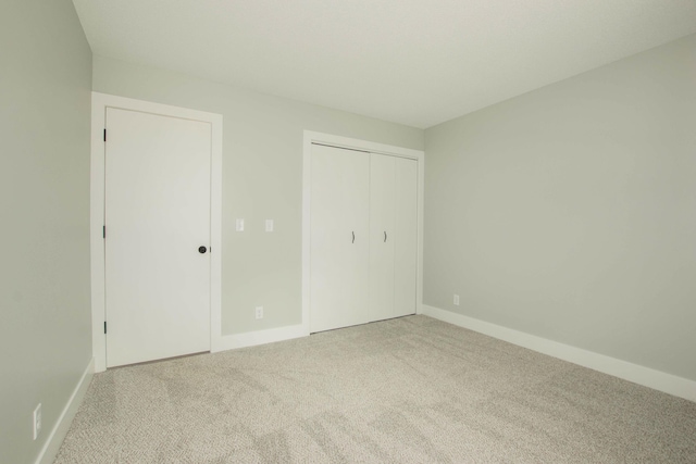 81 Skyline Cir NW, Grand Rapids, MI 49504 - unfurnished bedroom with carpet flooring, baseboards, and a closet