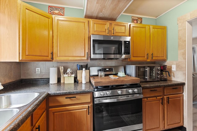 2045 Adams St, Adrian, MI 49221 - kitchen featuring stainless steel appliances, dark countertops, tasteful backsplash, ornamental molding, and a sink