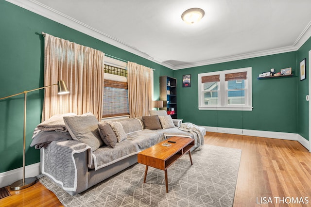 639 College Ave NE, Grand Rapids, MI 49503 - living room featuring crown molding, wood finished floors, plenty of natural light, and baseboards