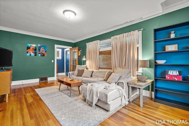 639 College Ave NE, Grand Rapids, MI 49503 - living room featuring crown molding, wood finished floors, built in features, and baseboards