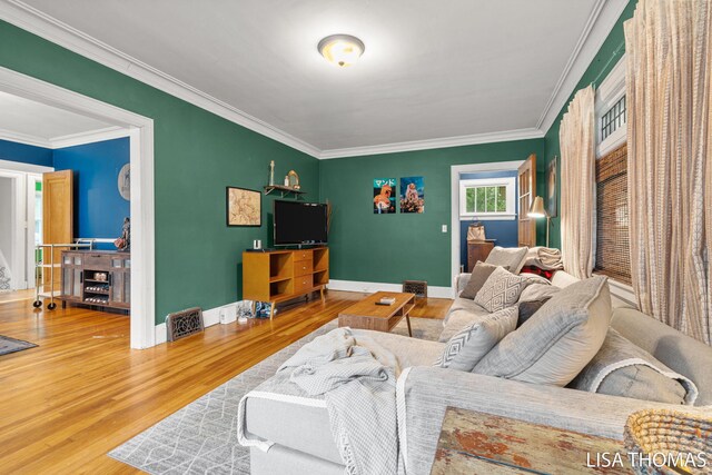639 College Ave NE, Grand Rapids, MI 49503 - living area featuring wood finished floors, ornamental molding, and baseboards