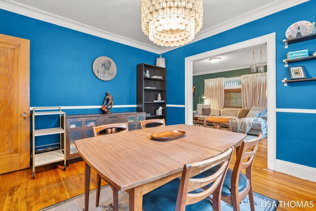 639 College Ave NE, Grand Rapids, MI 49503 - dining room featuring crown molding, wood finished floors, and baseboards