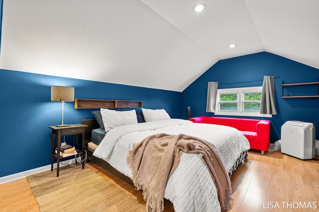 639 College Ave NE, Grand Rapids, MI 49503 - bedroom with wood finished floors, vaulted ceiling, baseboards, and recessed lighting
