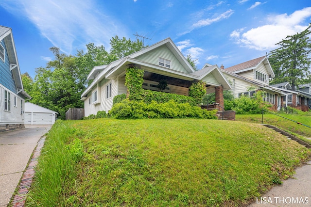 639 College Ave NE, Grand Rapids, MI 49503 - view of front facade featuring a front yard, a garage, and an outbuilding
