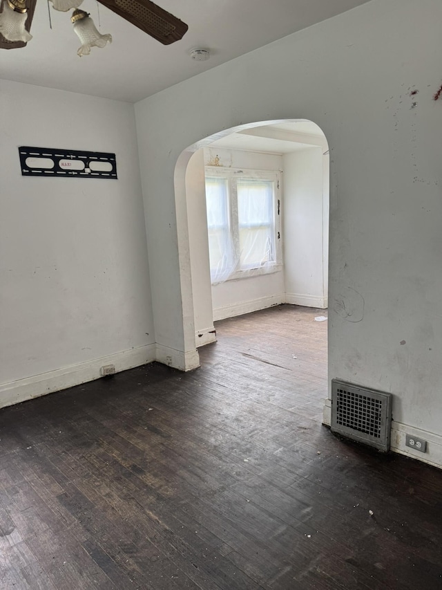 1101 W Rankin St, Flint, MI 48504 - unfurnished room with arched walkways, hardwood / wood-style flooring, a smoke detector, and baseboards