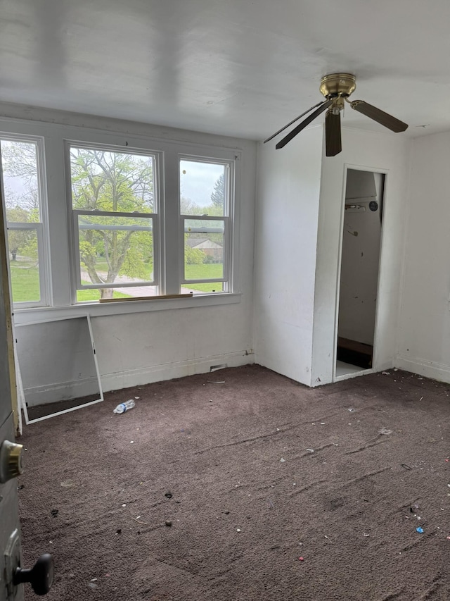 1101 W Rankin St, Flint, MI 48504 - carpeted empty room with healthy amount of natural light and ceiling fan
