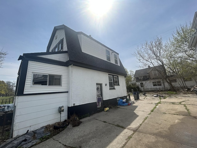 1101 W Rankin St, Flint, MI 48504 - view of property exterior with a shingled roof and stucco siding