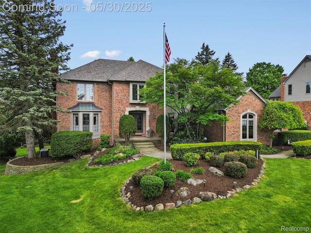1552 Pebble Creek Dr, Rochester, MI 48307 - traditional-style home with brick siding, a front lawn, and a shingled roof