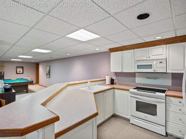 1552 Pebble Creek Dr, Rochester, MI 48307 - kitchen with white appliances, a sink, a peninsula, a paneled ceiling, and white cabinets
