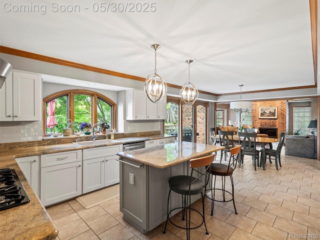 1552 Pebble Creek Dr, Rochester, MI 48307 - kitchen with a sink, backsplash, a kitchen island, healthy amount of natural light, and ornamental molding