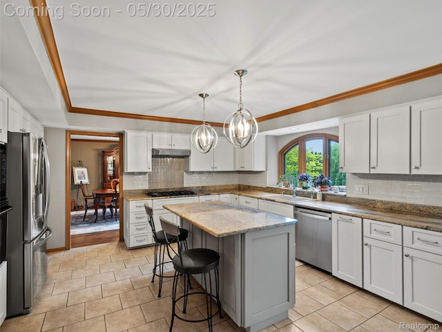 1552 Pebble Creek Dr, Rochester, MI 48307 - kitchen featuring appliances with stainless steel finishes, a sink, tasteful backsplash, a kitchen island, and under cabinet range hood