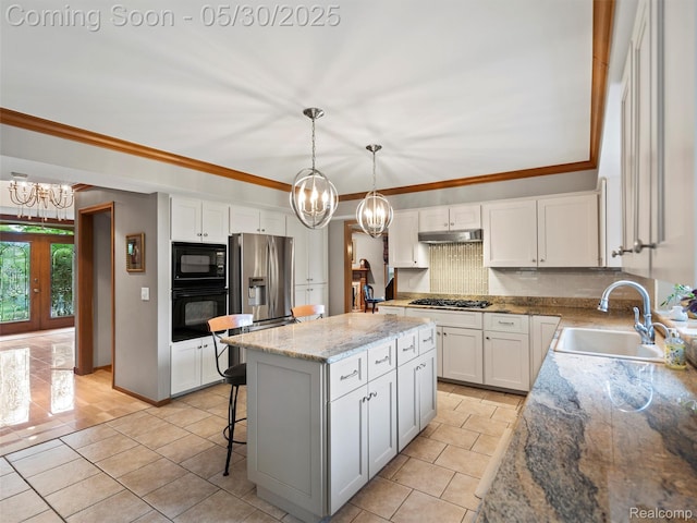 1552 Pebble Creek Dr, Rochester, MI 48307 - kitchen with black appliances, a sink, a chandelier, under cabinet range hood, and backsplash