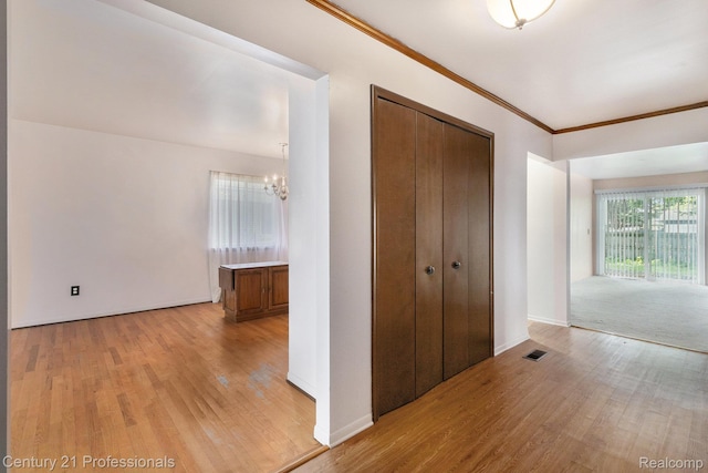 18201 Filmore St, Southfield, MI 48075 - hall with light wood-type flooring, a chandelier, and crown molding