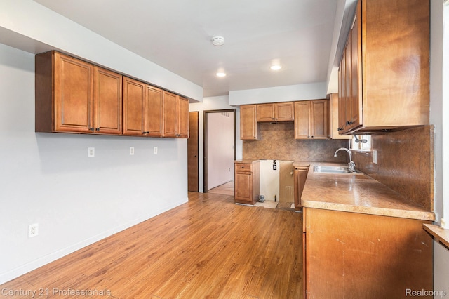 18201 Filmore St, Southfield, MI 48075 - kitchen featuring brown cabinetry, tasteful backsplash, light wood-style floors, and recessed lighting