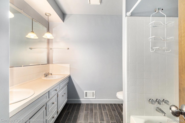 18201 Filmore St, Southfield, MI 48075 - bathroom featuring double vanity, wood finished floors, and bathing tub / shower combination