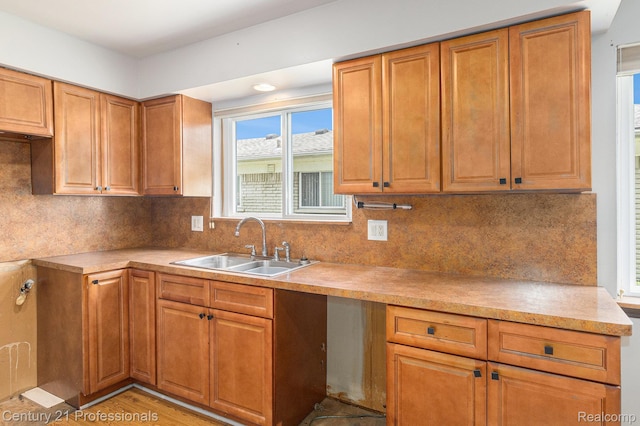 18201 Filmore St, Southfield, MI 48075 - kitchen with brown cabinetry, light countertops, and backsplash