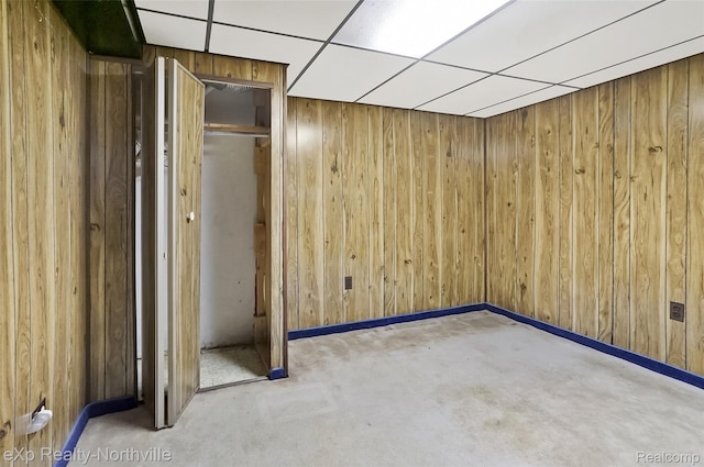 37923 Howell St, Livonia, MI 48154 - empty room featuring wood walls, a paneled ceiling, and baseboards