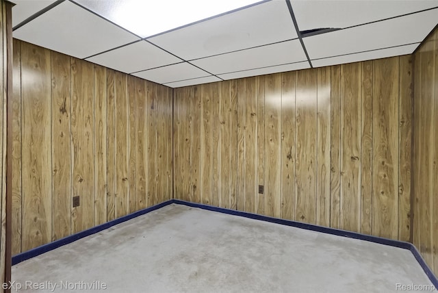 37923 Howell St, Livonia, MI 48154 - empty room featuring wood walls, a paneled ceiling, baseboards, and concrete floors