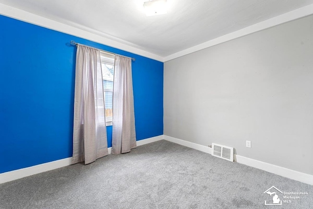 2011 5th St, Wyandotte, MI 48192 - spare room featuring baseboards and carpet