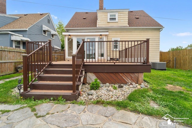 2011 5th St, Wyandotte, MI 48192 - back of house with a wooden deck, central air condition unit, a chimney, roof with shingles, and stairs