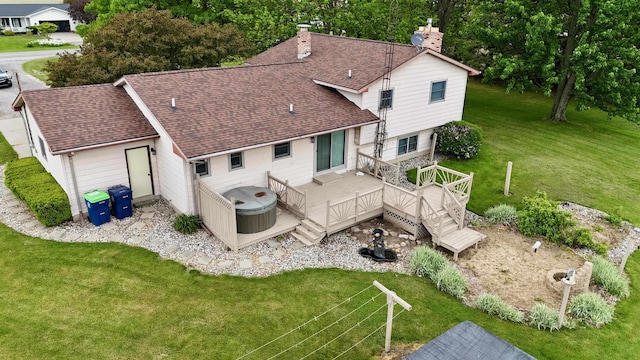 19379 Lincoln Rd, New Lothrop, MI 48460 - rear view of property with a chimney, roof with shingles, and a lawn