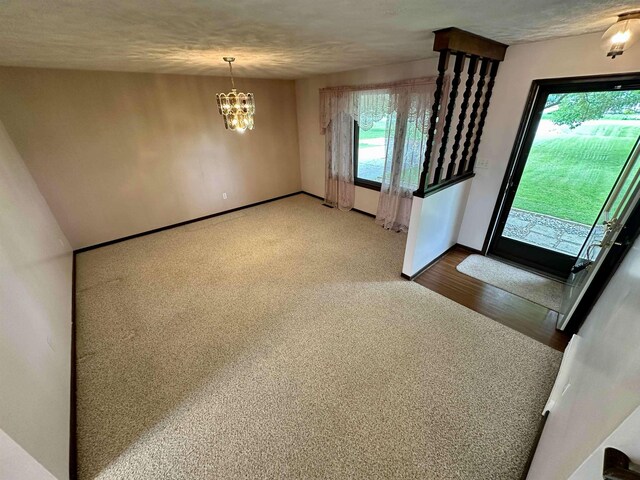 19379 Lincoln Rd, New Lothrop, MI 48460 - entrance foyer with a chandelier, wood finished floors, and baseboards