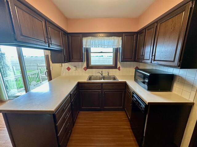 19379 Lincoln Rd, New Lothrop, MI 48460 - kitchen featuring black appliances, a sink, healthy amount of natural light, and dark wood-type flooring