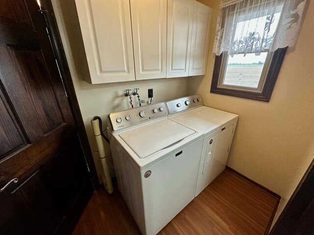 19379 Lincoln Rd, New Lothrop, MI 48460 - washroom featuring cabinet space, washer and dryer, and dark wood finished floors
