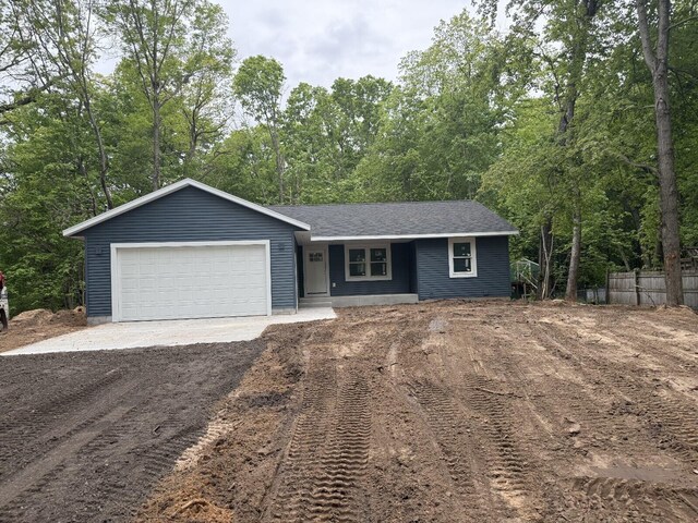 5667 Dalson Rd, Twin Lake, MI 49457 - ranch-style house with driveway, an attached garage, and a porch