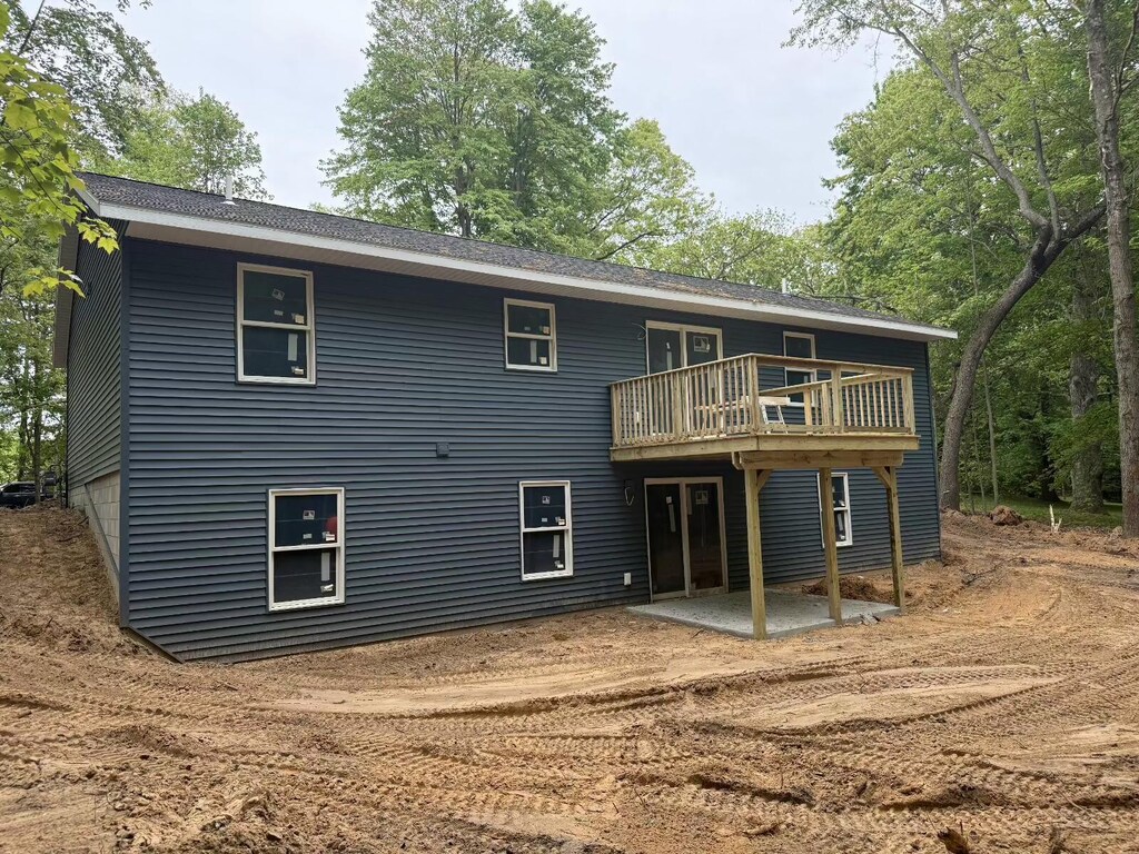 5667 Dalson Rd, Twin Lake, MI 49457 - rear view of property with a patio area and a wooden deck